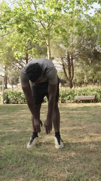 Young athlete stretching in park slow motion montage