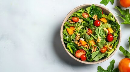 A vibrant salad bowl filled with fresh greens, cherry tomatoes, and chunks of fruit, presented on a light surface.