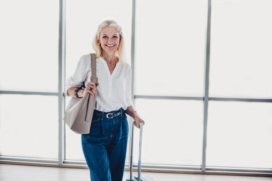 Happy Woman Traveler Standing at Airport Terminal Ready for a New Adventure During a Scenic Summer Journey - Powered by Adobe