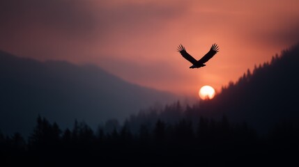 An eagle gracefully flies above misty mountain silhouettes at sunset, creating a striking and serene natural scene.