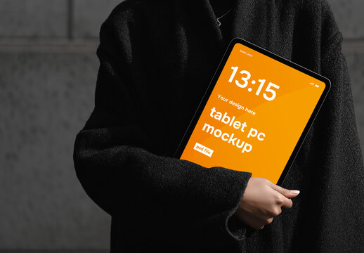 Tablet screen website mockup with woman holding tablet dressed in modern black