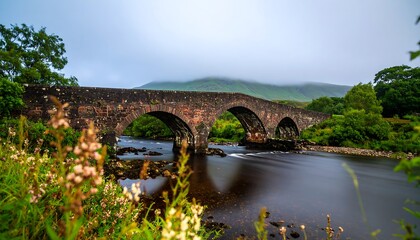Stone Bridge Over River in Misty Mountains