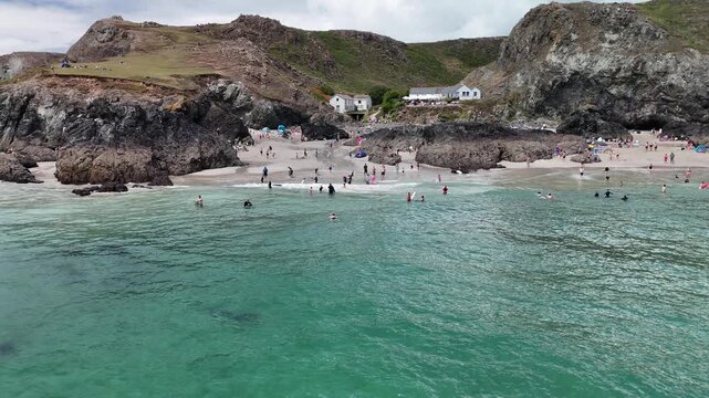 Aerial view of turquoise waters and sandy beach at Kynance Cove in Cornwall England.