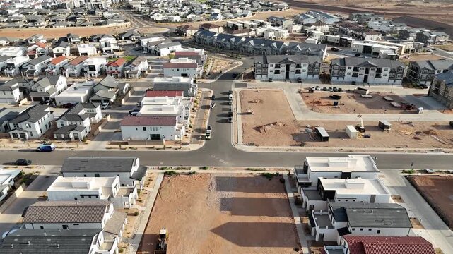 View of an empty lot surrounded by homes in St George, Utah suburb on a sunny day
