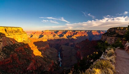 Sunset over vast canyon, colorful rock formations