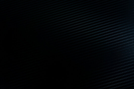 abstract blue black background. close-up of a carbon fiber pattern, black abstract background.