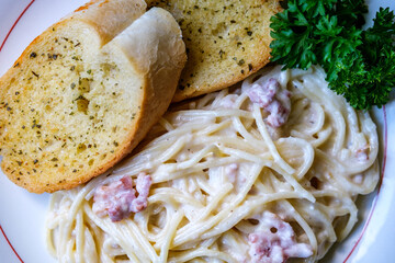 Italian Style Spaghetti Carbonara With Bacon Lardons And Creamy Parmesan Sauce And Garlic Bread