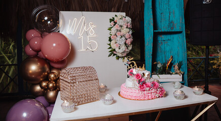 quinceanera cake and decoration with flowers