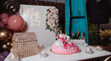 quinceanera cake and decoration with flowers