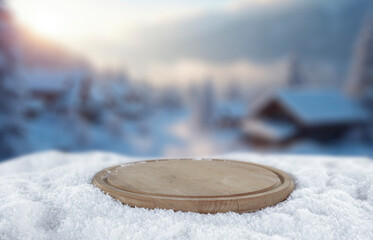 Empty copy space on fresh snow with background of frozen winter mountains and clear blue sky on sunny day. Concept of winter holidays, seasonal product placement, cold weather and mountain nature.