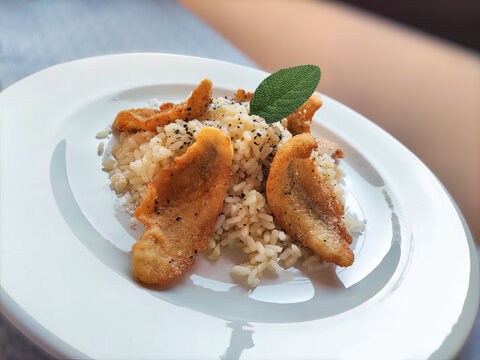 Portion of rice with fried perch fillets