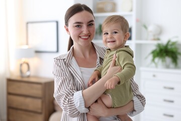 Mother with her cute little baby at home
