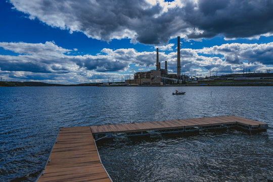 Mount Storm Lake, Grant County, West Virginia, USA | The wooden dock juts into the choppy waters of the reservoir as heavy clouds sweep across the sky. On the far shore, the Mount Storm Power Station 