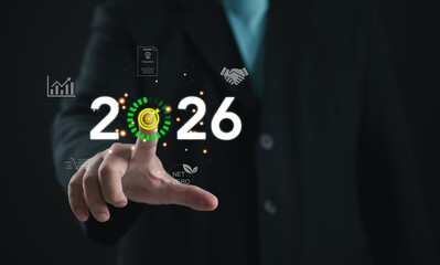 Businessman touching virtual target icon with year 2026. Concept of future planning, business goals, strategy, and sustainable growth for corporate success and long-term objectives.