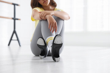 Teenage girl in tap shoes indoors, closeup