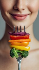 Smiling Woman with Vegetables Stacked on a Fork