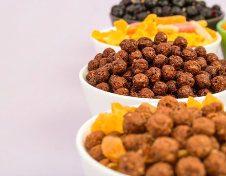 Assorted breakfast cereals in white bowls