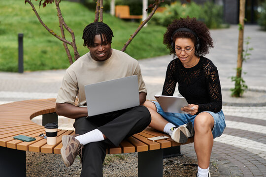Young couple enjoying remote work in a vibrant urban setting during summer