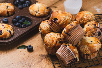 Blueberry muffins on a rustic table in a mold