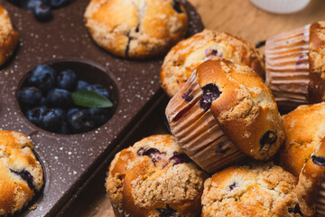Blueberry muffins on a rustic table in a mold