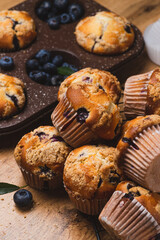 Blueberry muffins on a rustic table in a mold