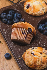 Blueberry muffins on a rustic table in a mold