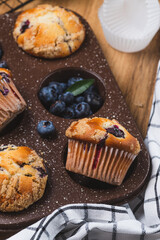 Blueberry muffins on a rustic table in a mold