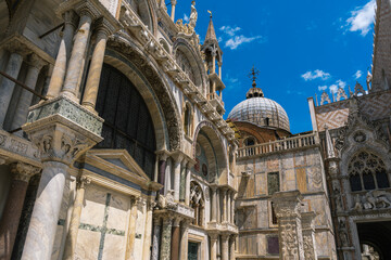 Fototapeta premium Architectural splendor: Ornate facade, pillars, and domes against a vibrant blue sky showcase intricate craftsmanship and classic design.
