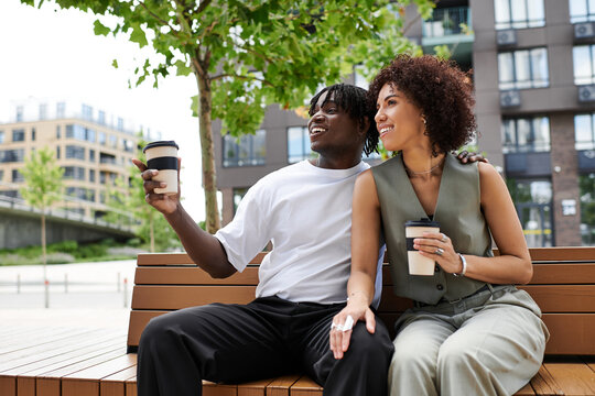 Stylish young couple enjoys summer day together in vibrant city park