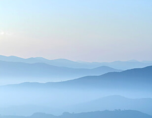 Obraz premium Serene blue mountain range landscape view with layers of haze creating tranquil nature background. soft morning light on distant peak creates peaceful mood