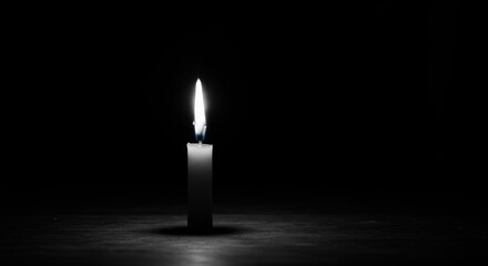 Fototapeta premium Solitary Candle Flame Illuminating Darkness, Symbolism of Hope and Remembrance