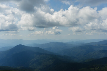 clouds over the ukrainian carpathian mountains view from hoverla peak highest in the country with green beautiful valleys in summer 