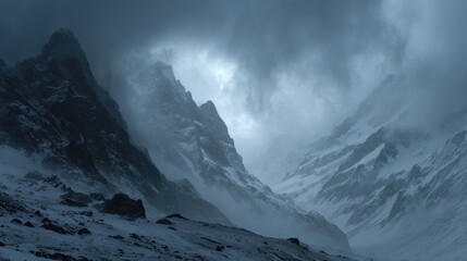 Snow-covered mountain landscape with steep peaks rugged terrain and dramatic cloudy sky du winter daytime