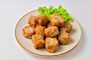 Deep Fried Crab Meat Roll, thai called hoi jo in a white plate