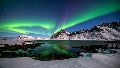 Naklejka premium Majestic aurora borealis over a winter landscape
