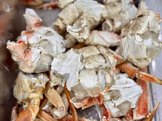 Frozen king crab claws in the freezer for sale in the supermarket. Delicatessen meat for a healthy diet. Close-up