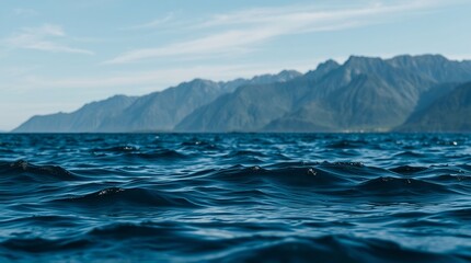 Ocean view with mountains in the background under a blue sky