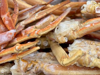 Frozen king crab claws in the freezer for sale in the supermarket. Delicatessen meat for a healthy diet. Close-up