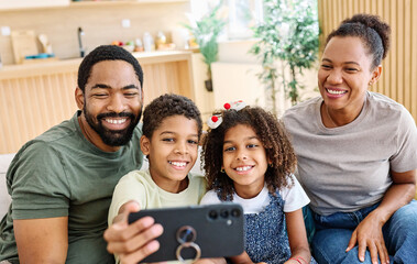 Portrait of a happy black family mother father and kids taking selfie with mobile phone having fun  at home on couch
