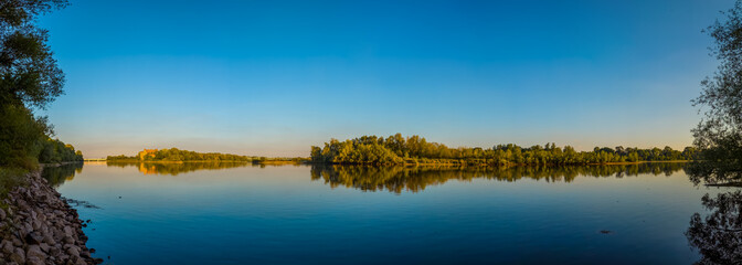 Panoramic view of a confluence of Narew (left) and Vistula (right) rivers with lush green banks.