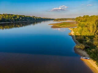 High angle view of a confluence of Narew (left) and Vistula (right) rivers with lush green banks.