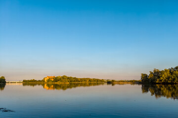 A confluence of Narew (left) and Vistula (right) rivers with lush green banks.