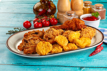 Golden crispy fried chicken mix - wings, drumsticks, nuggets and strips