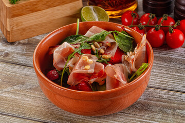 Salad with jamon, strawberry and arugula