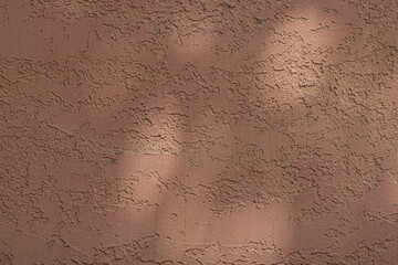 Wall with texture and shadows. Orange, brown concrete background