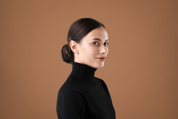 Portrait of beautiful woman on brown background