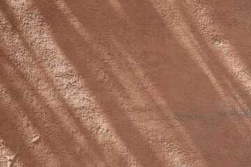 Wall with texture and shadows. Orange, brown concrete background