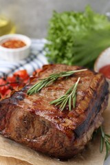 Delicious roast beef with rosemary on table, closeup