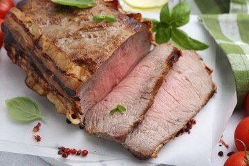 Delicious baked beef meat and spices on table, closeup