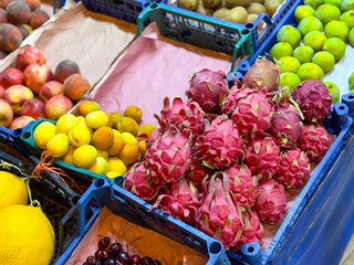 Exotic dragonfruit and seasonal fruits displayed at a local market. Freshness, nutrition, and...